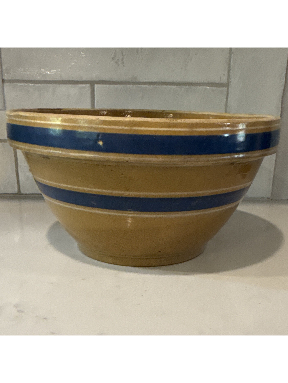 This is an antique yellow ware mixing bowl with cobalt blue and whit bands.